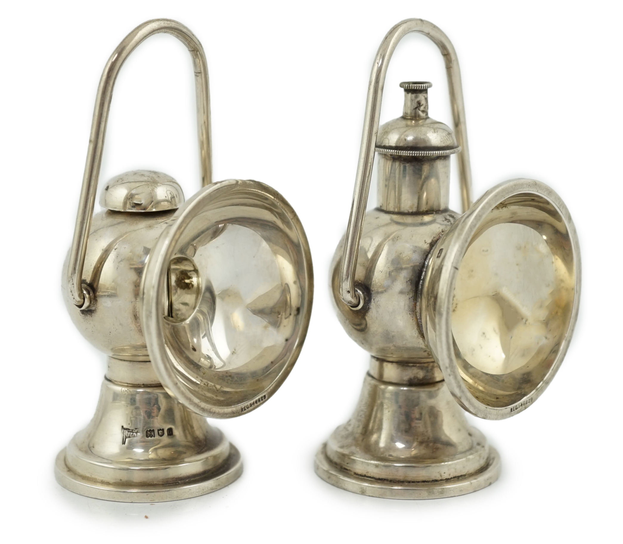 An Edwardian novelty cigar cutter and perpetual lighter, modelled as a pair of railway lamps, by Walker & Hall